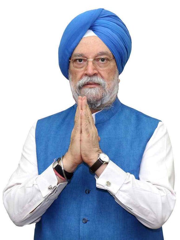 Hardeep Singh Puri in a blue turban and blue waistcoat with hands folded in a namaste greeting