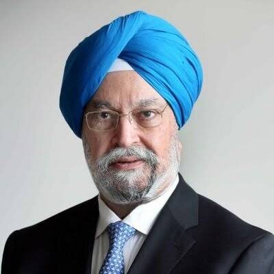 Portrait of Hardeep Singh Puri in a dark suit and patterned tie with a turquoise turban