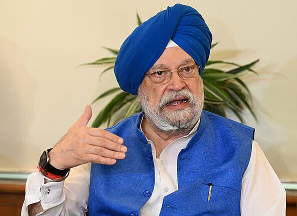 Hardeep Singh Puri in a blue turban gesturing while speaking in an interview