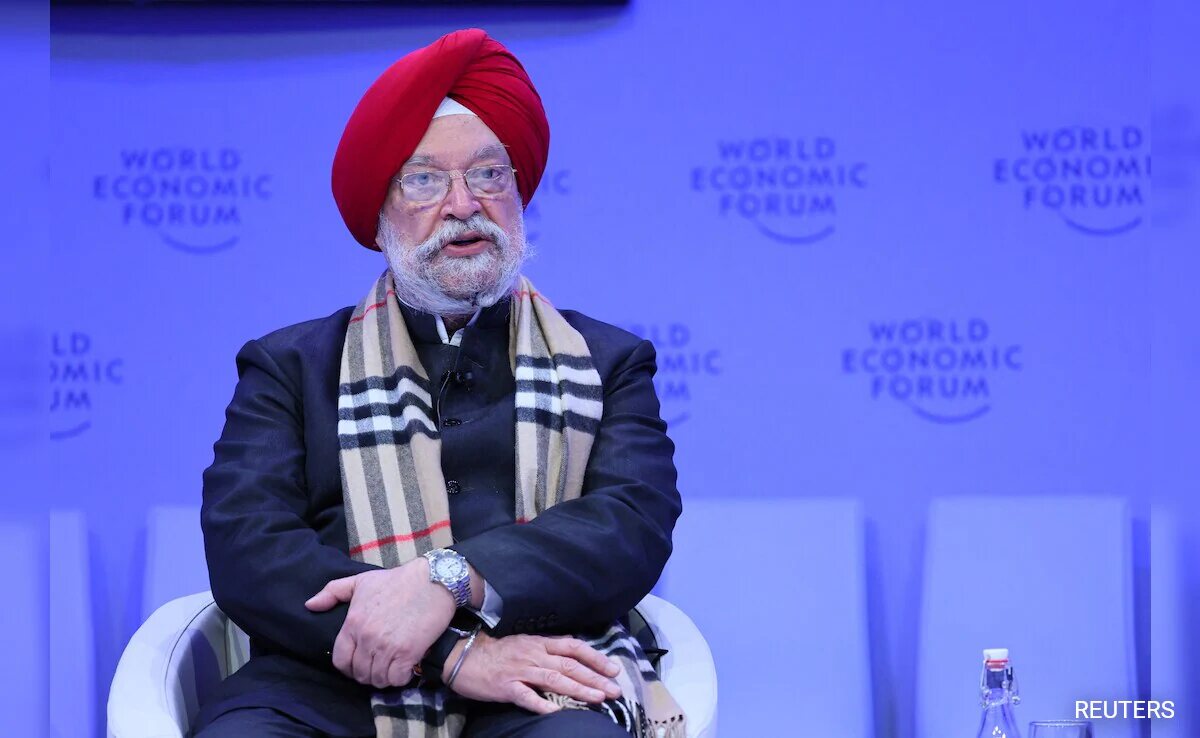 Hardeep Singh Puri in a red turban and patterned scarf seated on stage at the World Economic Forum